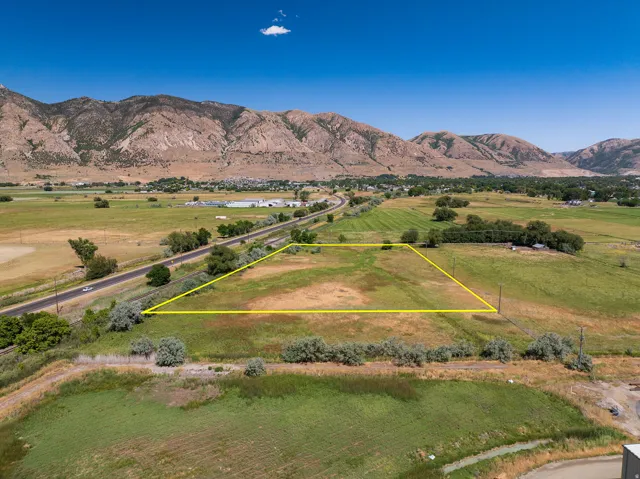 Expansive land parcel featuring open fields and distant mountain range