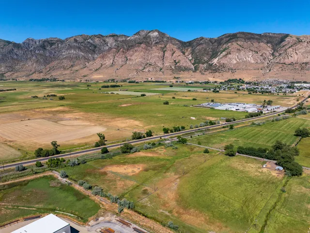 Expansive agricultural land featuring a diverse landscape with fields and distant mountains
