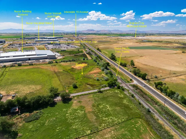 Expansive land parcel featuring open fields and distant mountain ranges