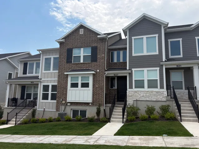 Contemporary townhome exterior featuring brick and siding accents