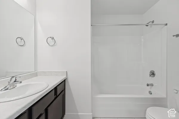 Vanity with an oval sink, chrome faucet, and dark wood-finish cabinetry