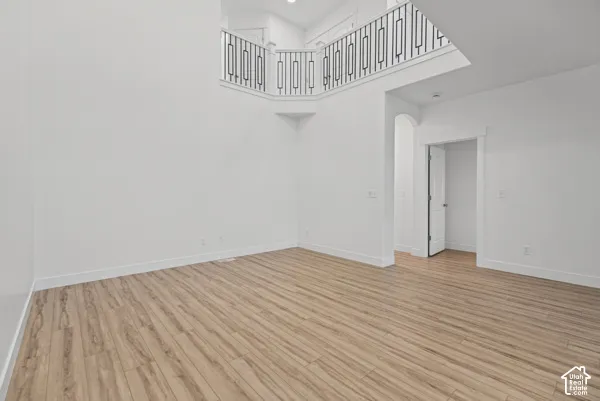 Wood-finish flooring with white baseboards