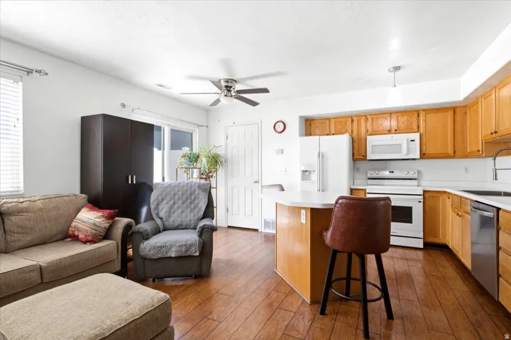 Open-concept kitchen and living area featuring wood-finish flooring