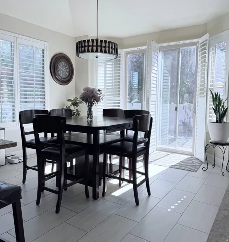 Dining area featuring light wood-finish flooring and a contemporary drum chandelier