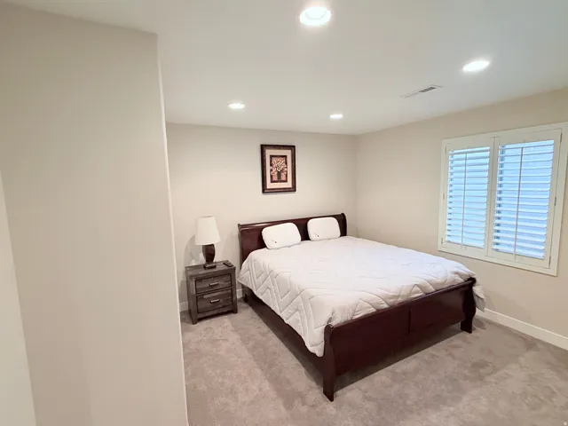 Room featuring light neutral wall paint, recessed ceiling lighting, and carpet flooring