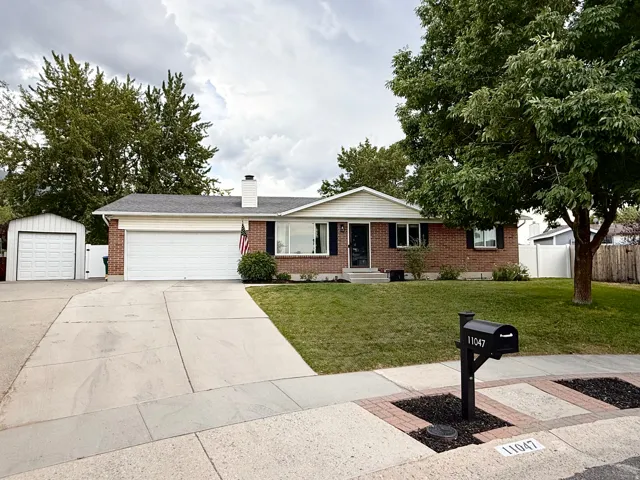 Brick and siding ranch-style exterior with a two-car garage