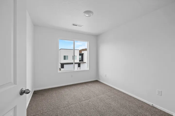 Neutral wall finishes with a single window providing natural light