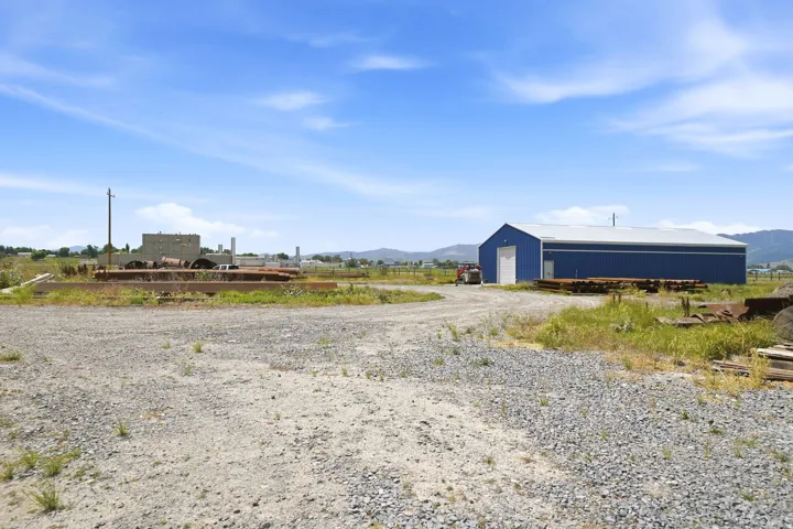 Large blue industrial building with a white roll-up door