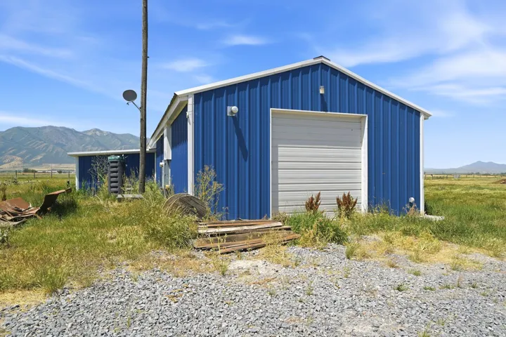 Metal-sided structure with a white roll-up garage door