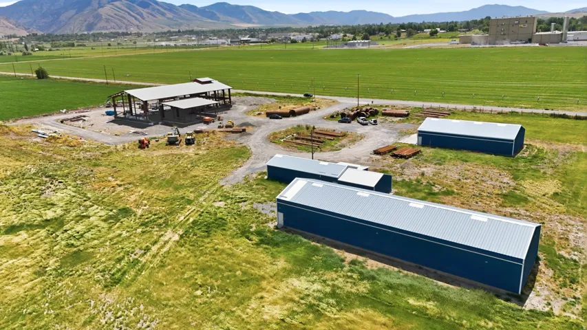 Expansive industrial property featuring two pre-engineered metal buildings with blue siding and metal roofs