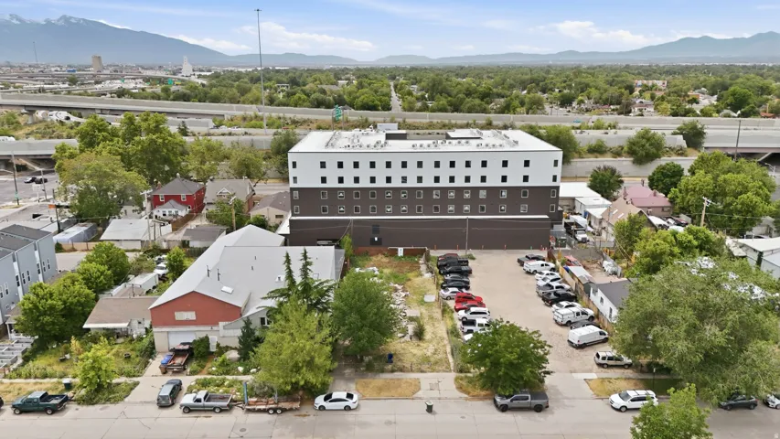 Large commercial building featuring a two-tone exterior with a light upper facade and dark lower levels