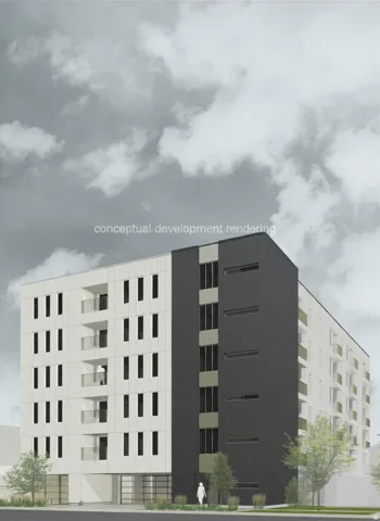 Contemporary multi-story building featuring a striking two-tone facade in white and charcoal