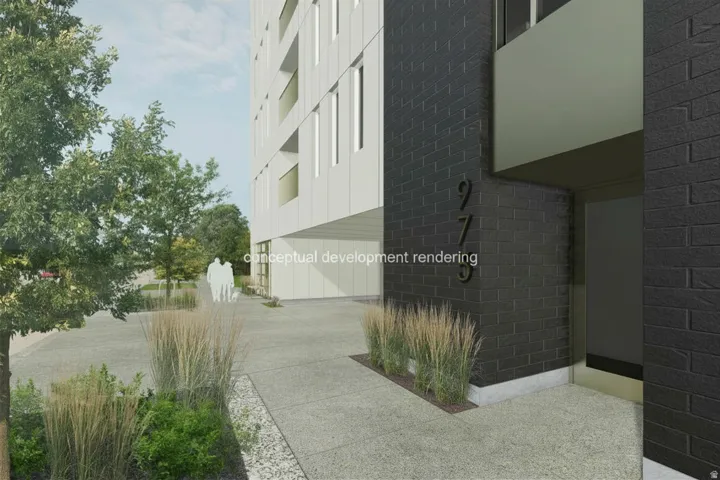 Modern building exterior featuring dark brick accents and white paneling