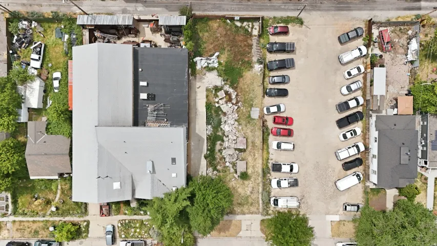 Overhead perspective showcasing a commercial property with a light-colored metal roof section and a darker flat roof section