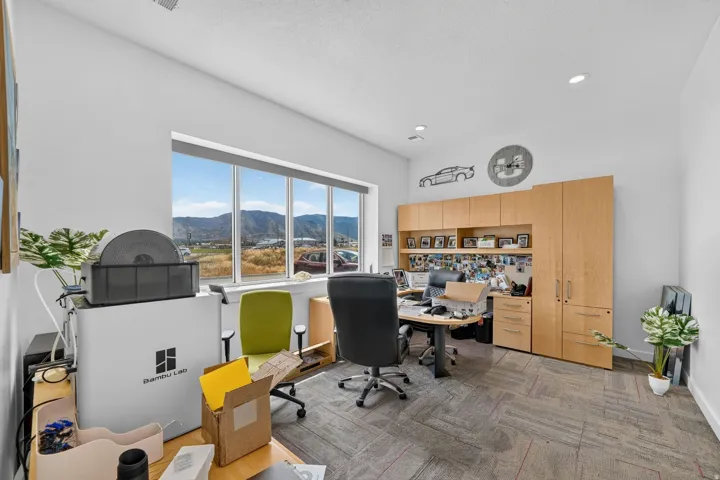 Room featuring large multi-panel windows, recessed lighting, and light gray walls