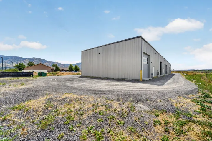 Industrial building featuring metal siding and multiple roll-up doors