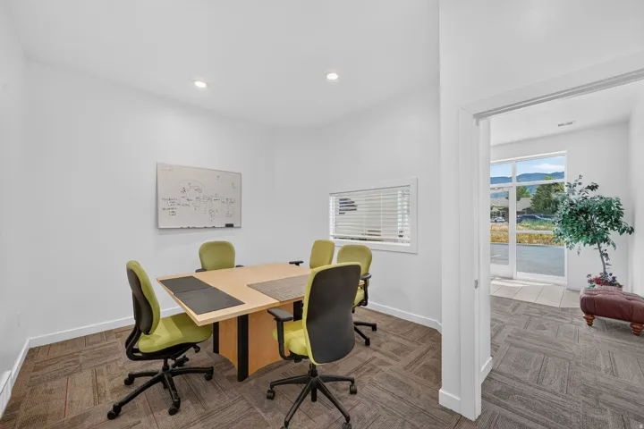 Private room featuring white walls, recessed lighting, and patterned carpet flooring