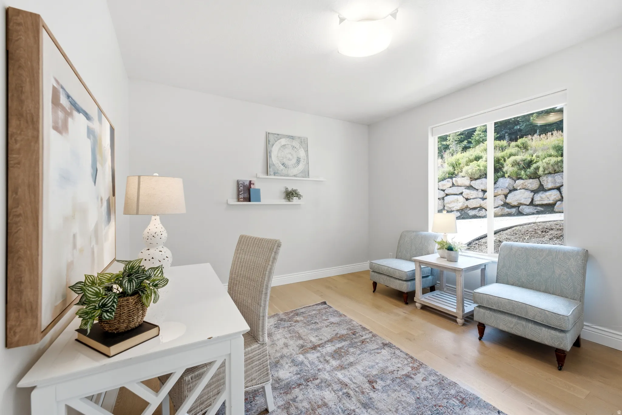 Bright interior space featuring light wood-finish flooring and a large window