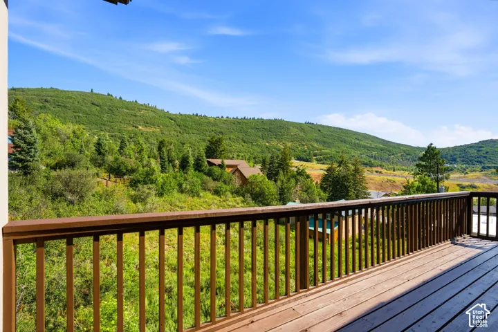 Expansive outdoor deck with wood-finish flooring and a wood railing system