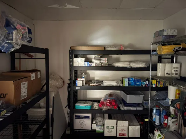 Storage area with white walls and a drop ceiling