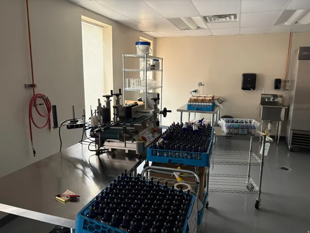 Commercial space featuring an industrial process line, stainless steel countertops, and a utility sink