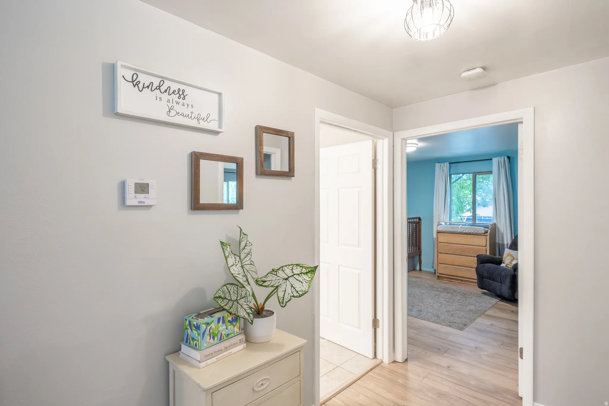 Hallway with light gray walls and wood-finish flooring