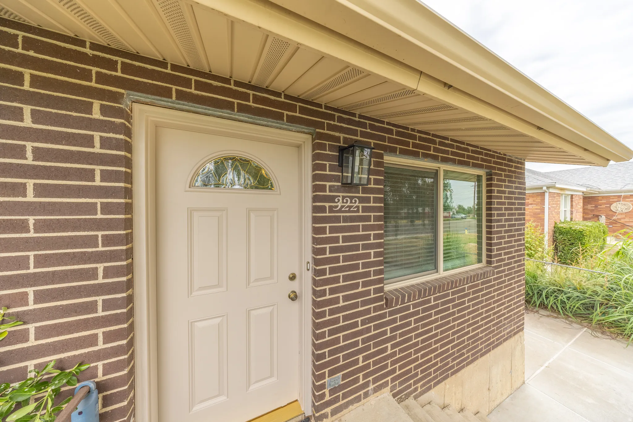 Brick exterior with light-colored siding soffit