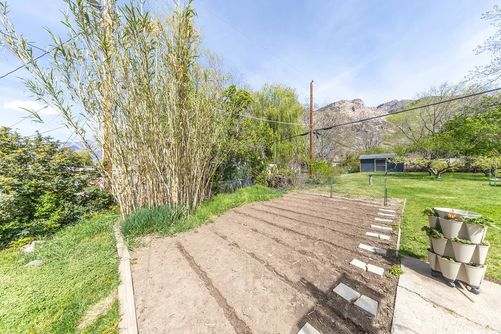 Expansive garden area featuring prepared planting beds and a gravel path