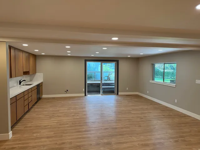 Open-concept living area featuring wood-finish flooring, recessed lighting, and neutral wall tones