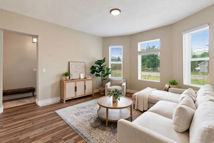 West unit. Spacious living area featuring wood-finish flooring, neutral wall tones, and recessed lighting
