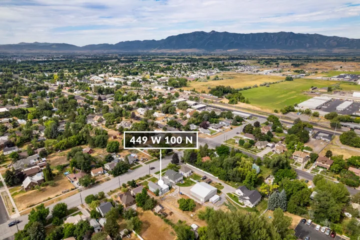 Aerial perspective showcasing a residential neighborhood with distant mountain ranges
