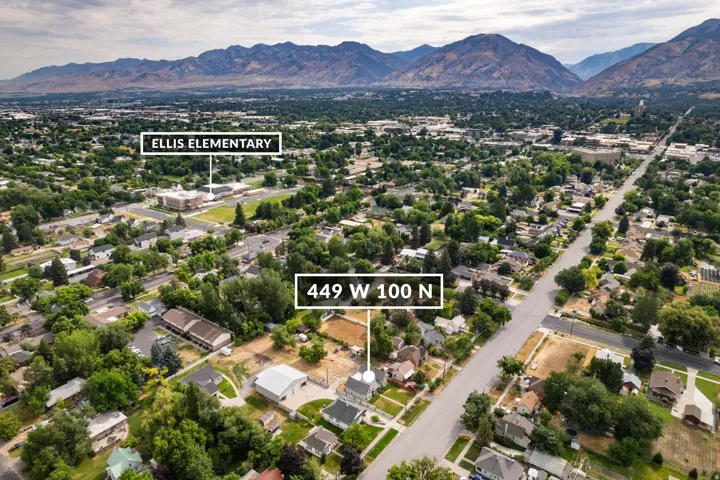 Aerial view of a developed neighborhood featuring residential properties and mature trees
