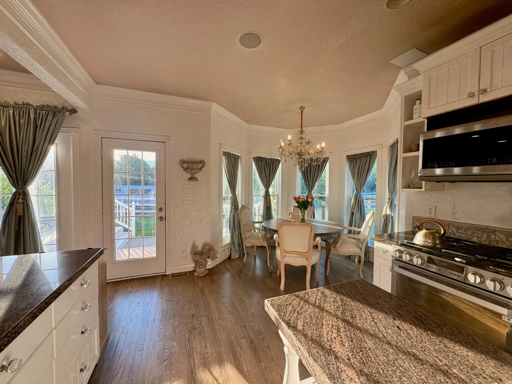 Expansive kitchen and dining area with wood-finish flooring
