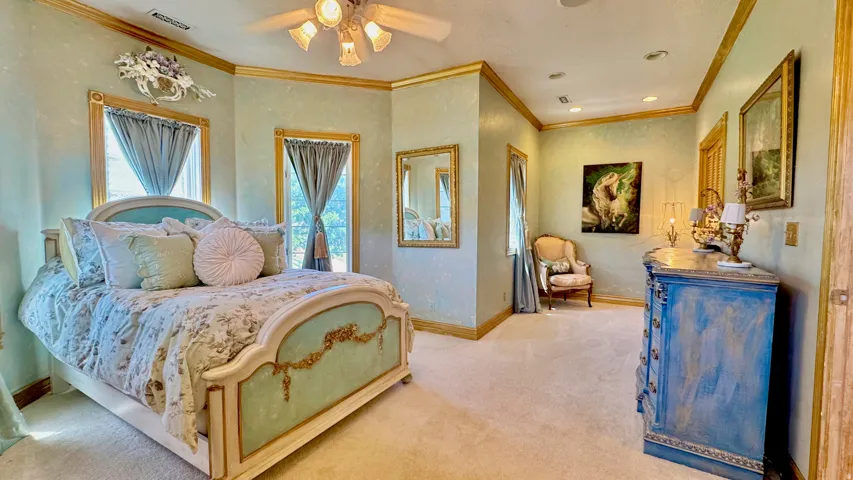 Textured walls with crown molding, recessed lighting, and a ceiling fan with light fixture