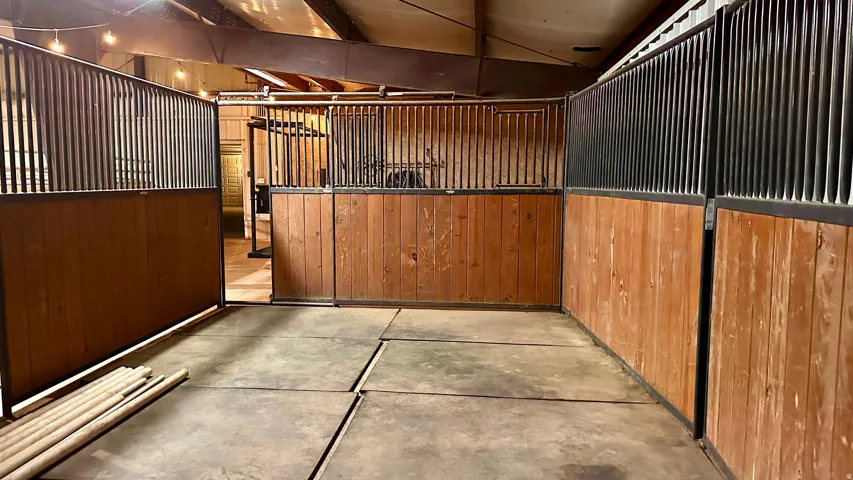 Interior stall space featuring wood paneling and metal bar upper sections