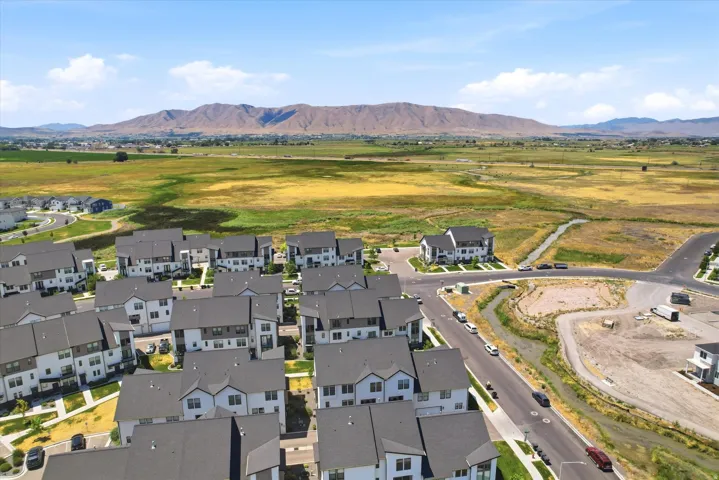 Aerial perspective showcasing a community of multi-story residences with dark roofs and light-colored facades