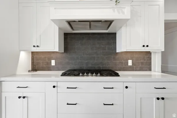 White shaker-style cabinetry with matte black hardware