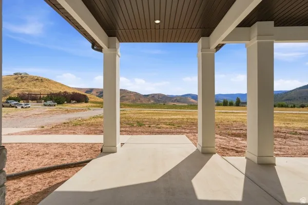 Covered porch featuring a concrete patio and recessed lighting