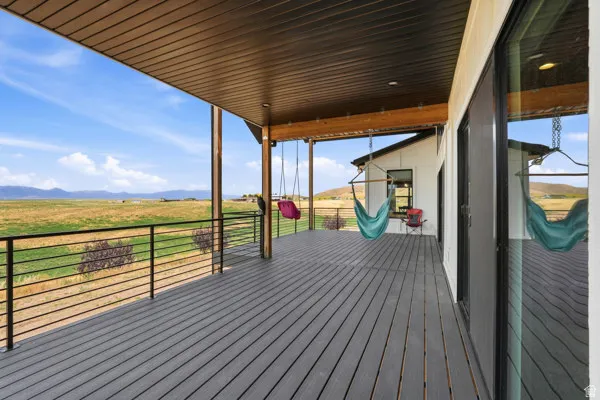 Expansive covered deck featuring composite decking and a metal railing system