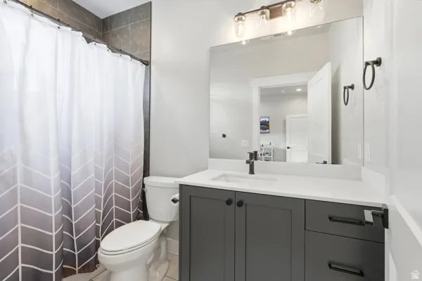 Bathroom featuring a dark gray vanity with a white countertop and rectangular undermount sink