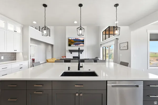 Expansive kitchen island with a dark gray base, white countertop, and integrated black sink