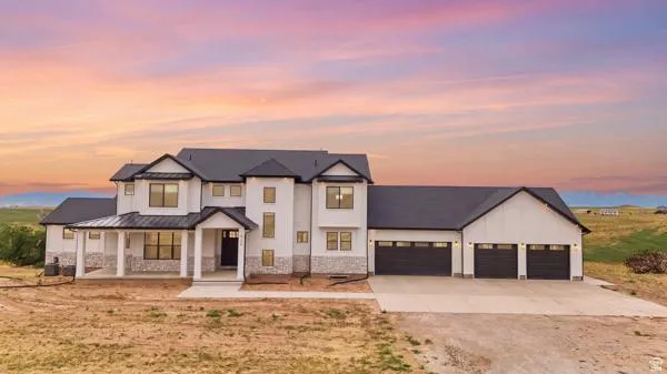 Modern farmhouse exterior featuring white siding, dark trim, and a black roof