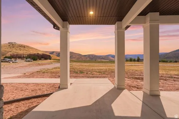 Covered porch with concrete flooring and a dark wood-finish ceiling
