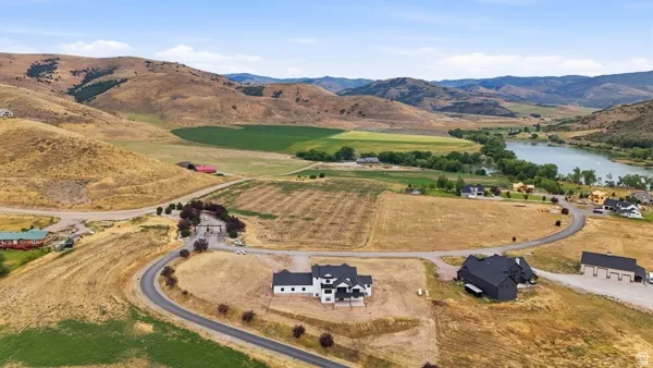 Expansive natural landscape featuring rolling hills and a visible body of water