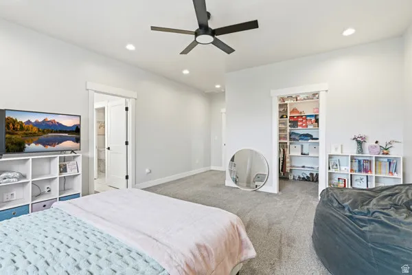 Spacious room featuring light gray carpeting, recessed lighting, and a contemporary ceiling fan