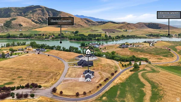 Aerial perspective showcasing multiple homesites with proximity to a body of water and distant mountains