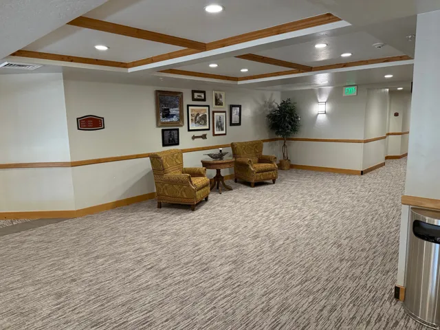 Foyer featuring patterned carpeting, recessed ceiling lighting, wood-finish trim, and wall-mounted sconces