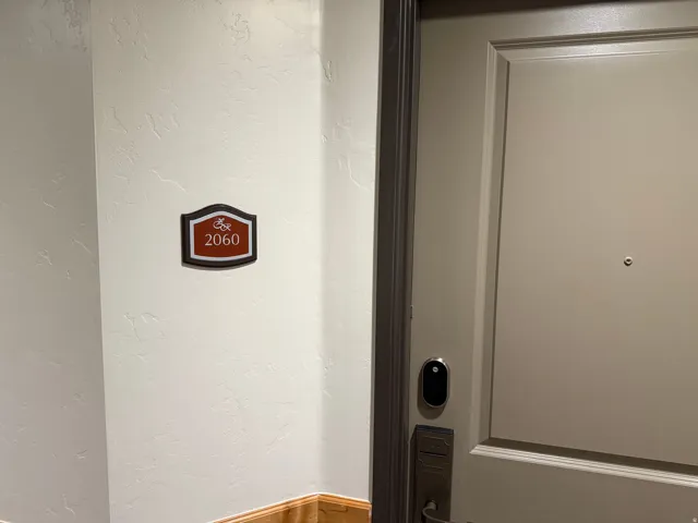 Painted door featuring a digital lock system, dark door frame, and a peephole