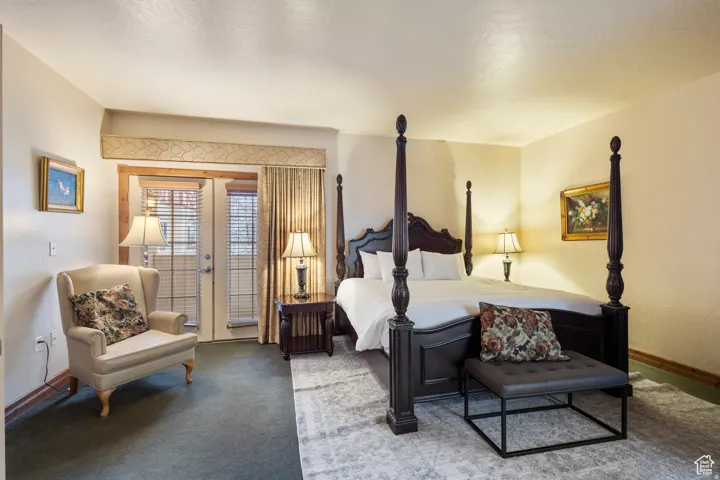 Bedroom featuring a large window and double doors