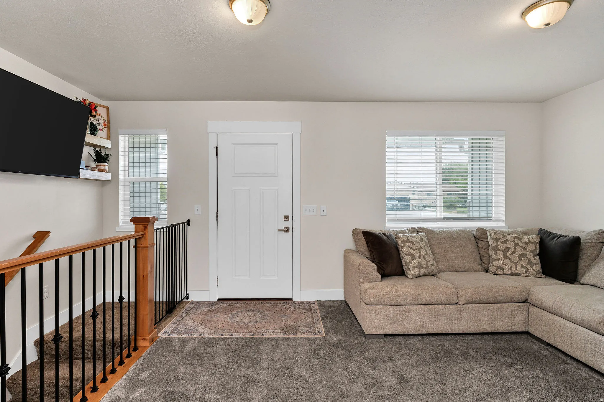 Entryway featuring a paneled door with brushed nickel hardware, surrounded by crisp white trim